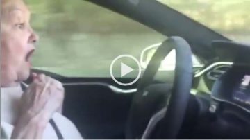 Still image of woman in driverless car. Click to play short video