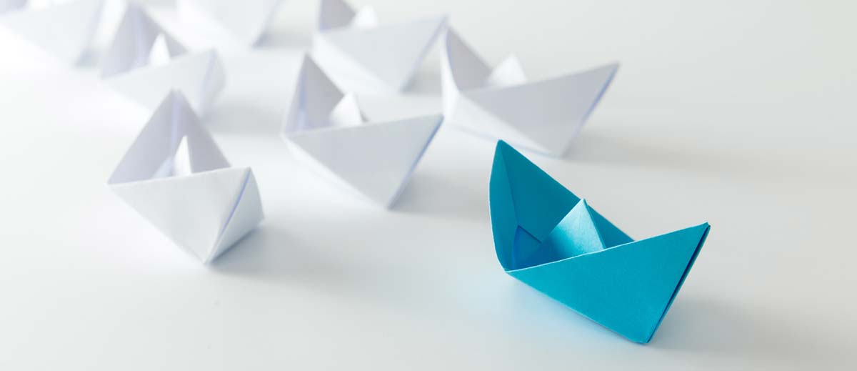 blue paper boat representing leadership