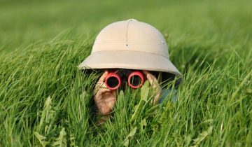 stealthy child looking through binoculars