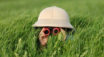 stealthy child looking through binoculars
