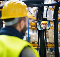 forklift driver face viewed in mirror