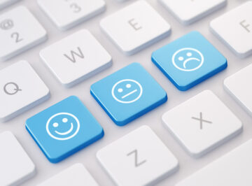Qwerty keyboard with; happy face, straight face and crying face keys
