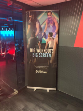 Les Mills advertisement - images of people working out with the words 'Big Workouts, Big Screen'