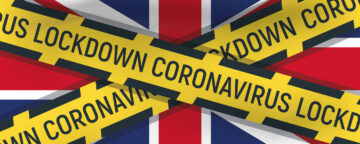 (alt=”A union jack flag with yellow tape warning tape over the top, with the words of Lockdown Coronavirus”)