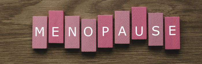 The word menopause written on pink wooden blocks.